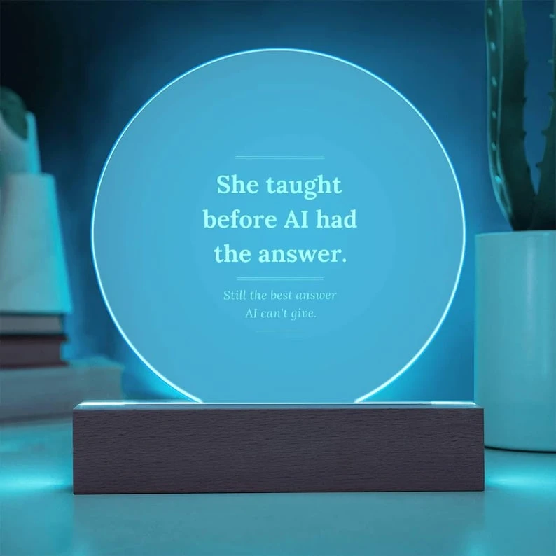 Teacher acrylic plaque glowing blue on its rectangular wooden LED base