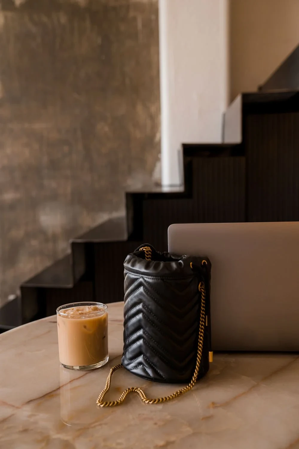Pre-loved luxury handbag styled with coffee