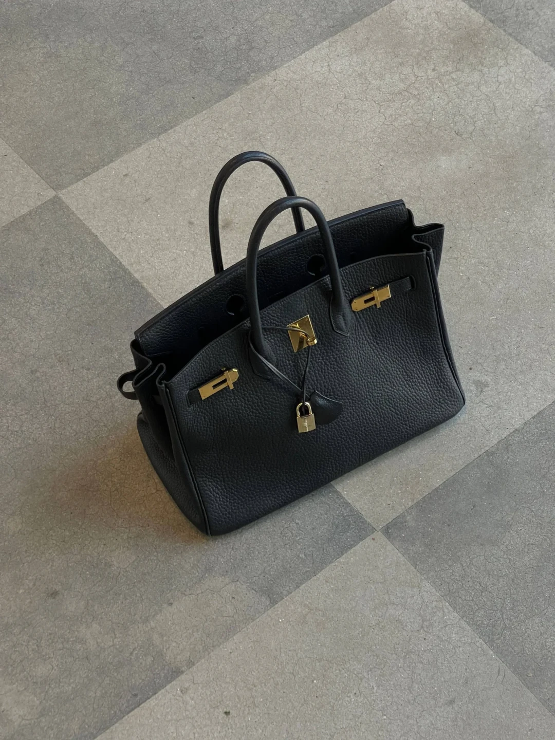 Black leather handbag on the floor